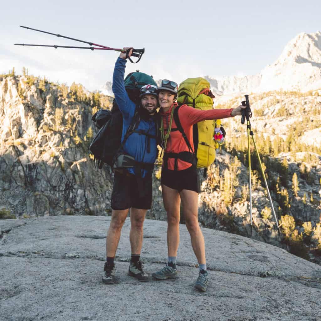Two people smiling on a beginner backpacking trip in the Sierra Nevada mountains