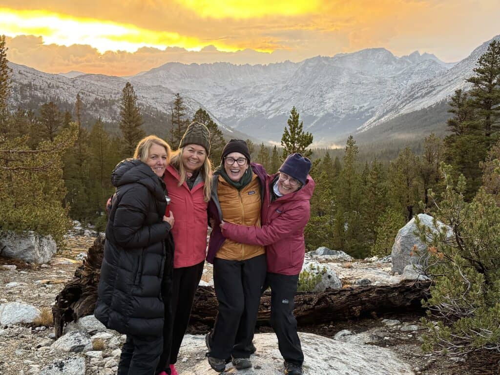 Women smiling and posing on the Sky Marathon trip in the Sierra Nevada