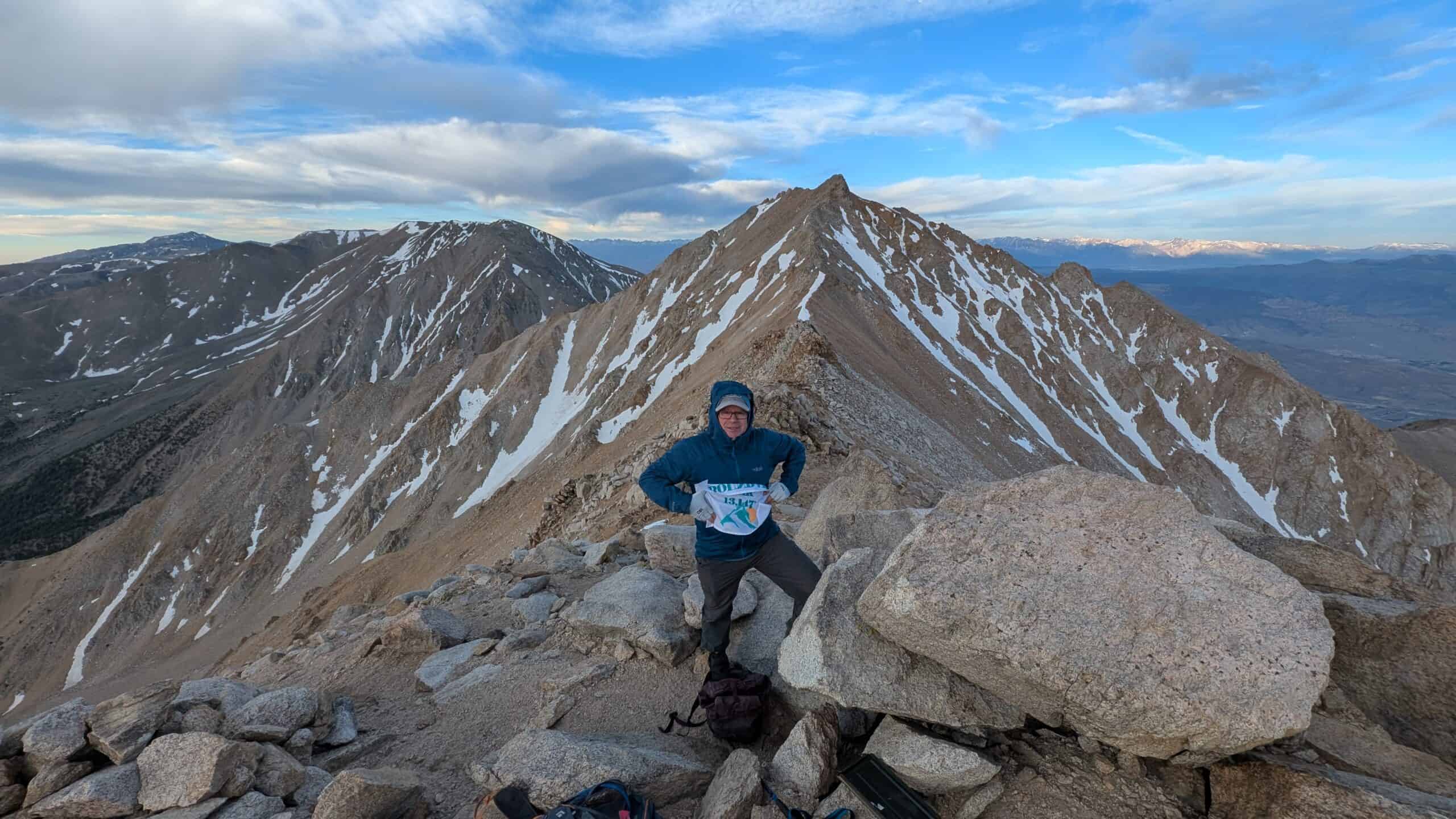 Hiker on the summit of Boundary Peak during a guided ascent with Sierra Mountain Center