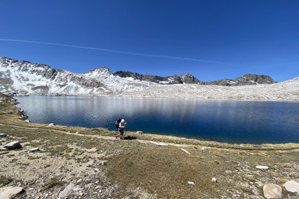 Hiker walking along Evolution lake